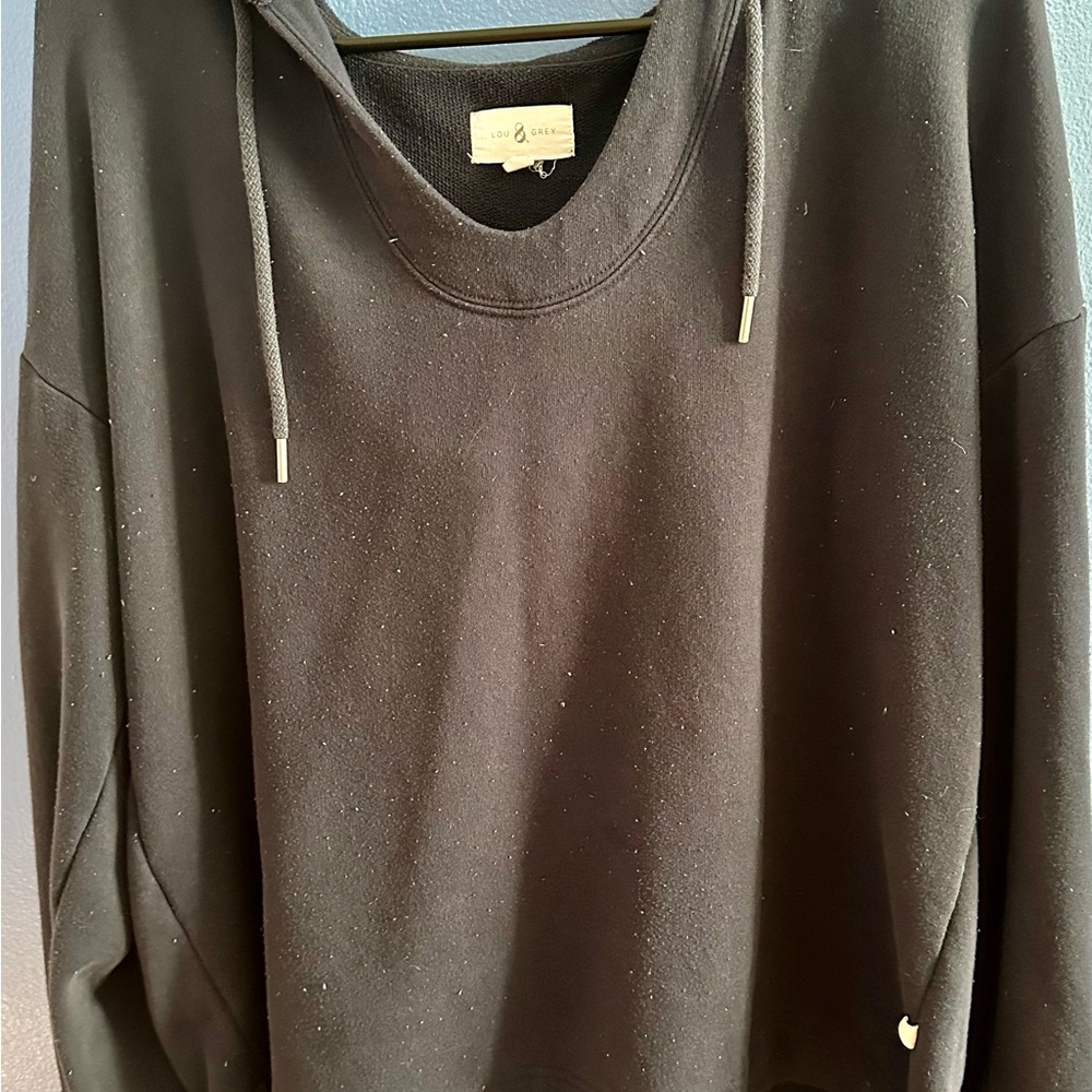 Blue sweater with a u shape neck and a hoodie and striped cuffed and the pants